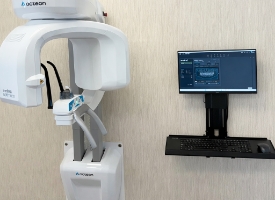 Dentist using intraoral camera on patient